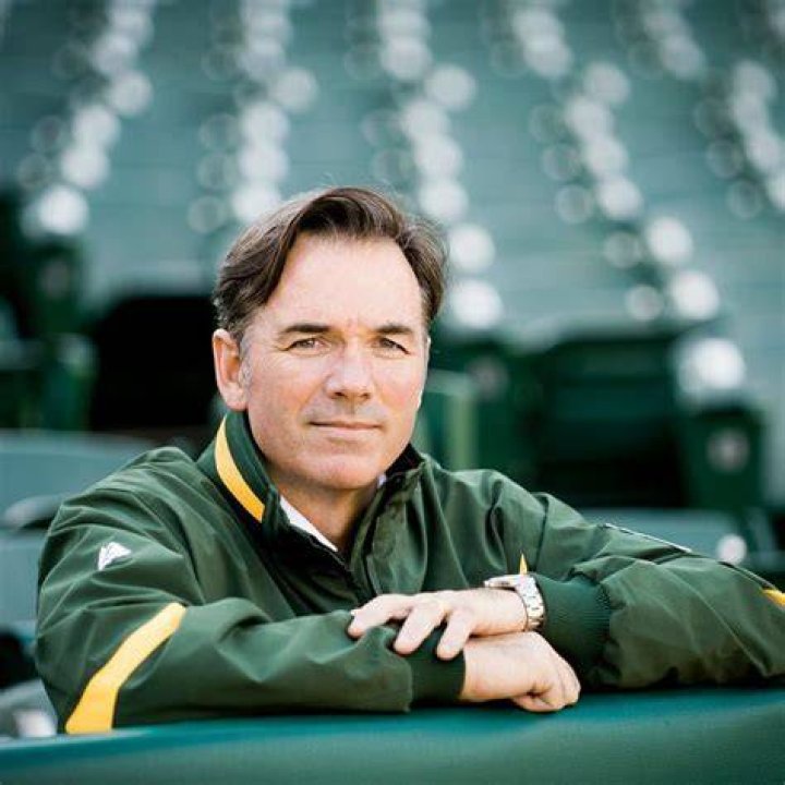 Billy Beane is posing with the bat as he is on his Oakland Athletics jersey.