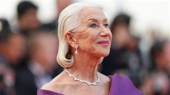 Helen Mirren posing with one of her best-selling books.