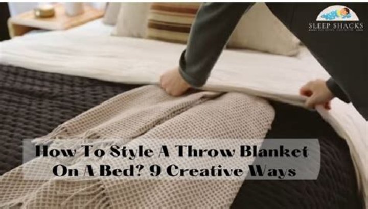 How do you put a throw on a bed?