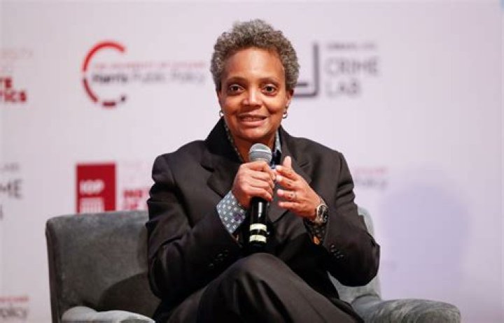 Lori Lightfoot in a black coat poses for a picture.